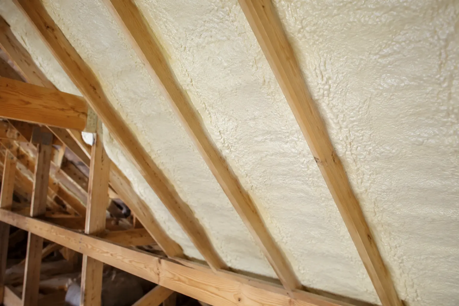 Closed-cell spray foam applied along an attic roofline